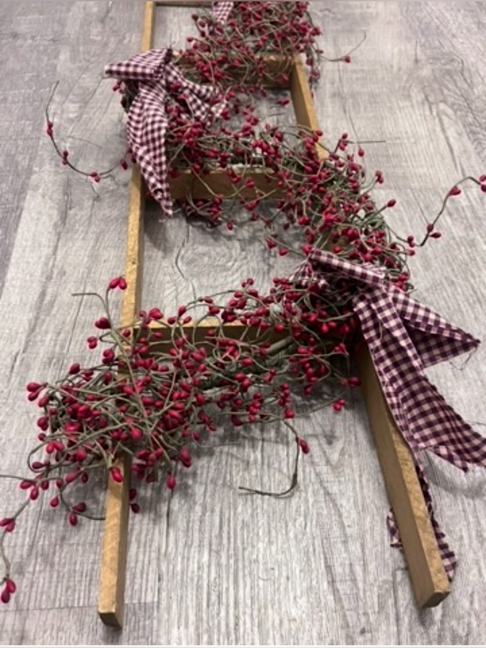 Rustic wood Ladder Shelf with Red Berry Garland and Plaid Bows